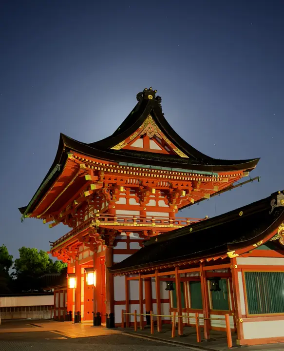 Orange shrine gate lit at dusk