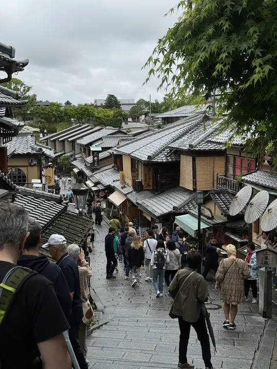 Crowds on a sloping street of wooden houses