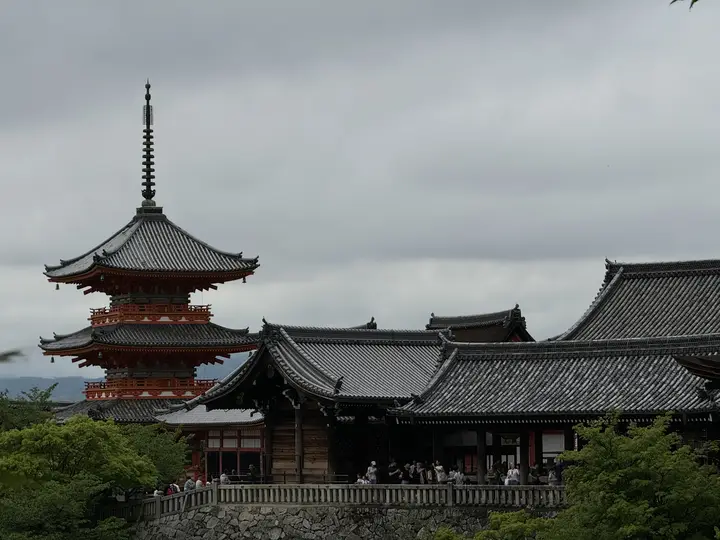 Red pagoda beside temple roofs