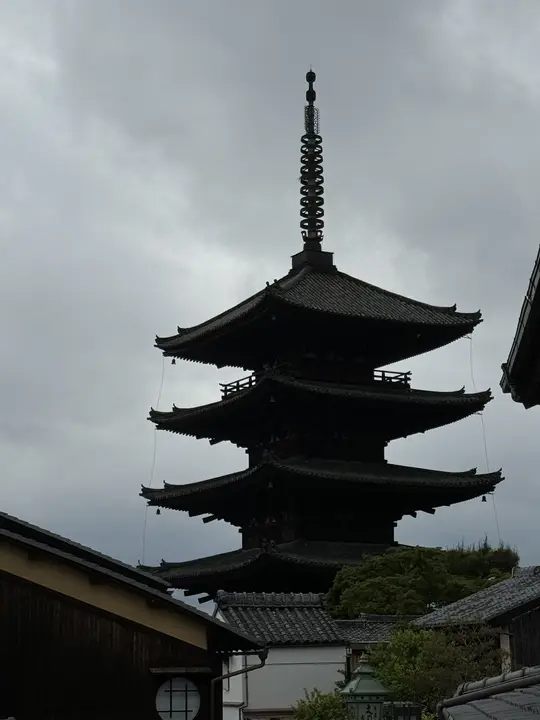Pagoda in silhouette under a grey sky