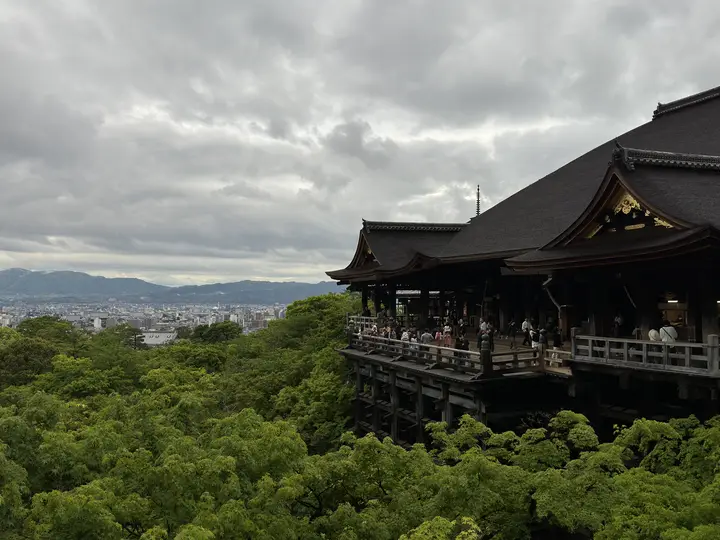 Wooden temple stage above green trees