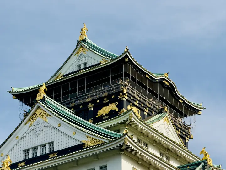 Gilded castle roof under a blue sky