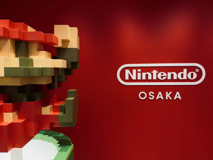 Pixel Mario beside the Nintendo Osaka sign