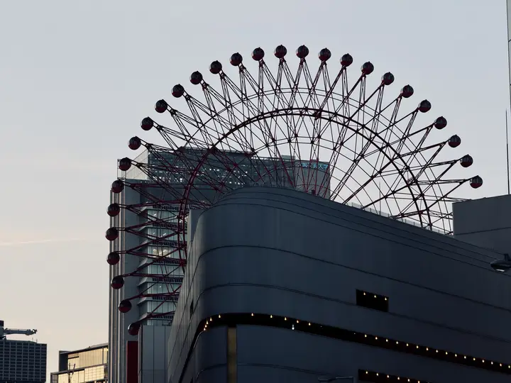 Ferris wheel above a building