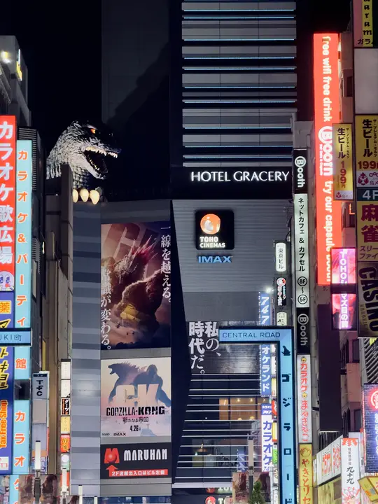 Neon signs up a narrow street