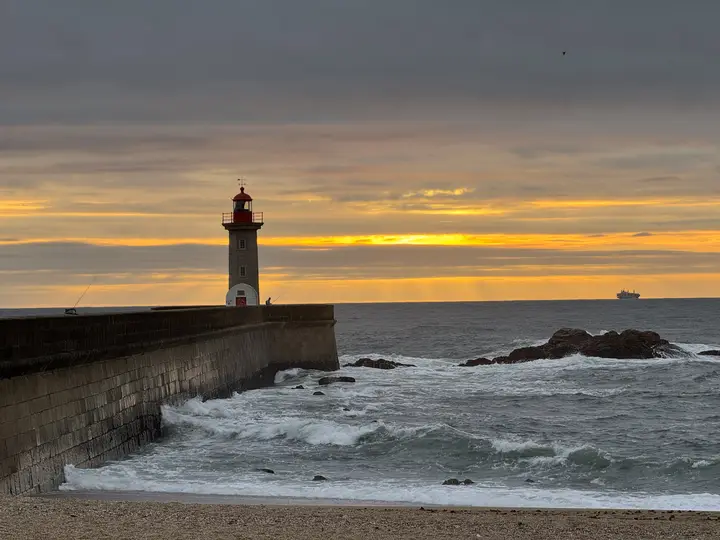Lighthouse on a pier at sunset