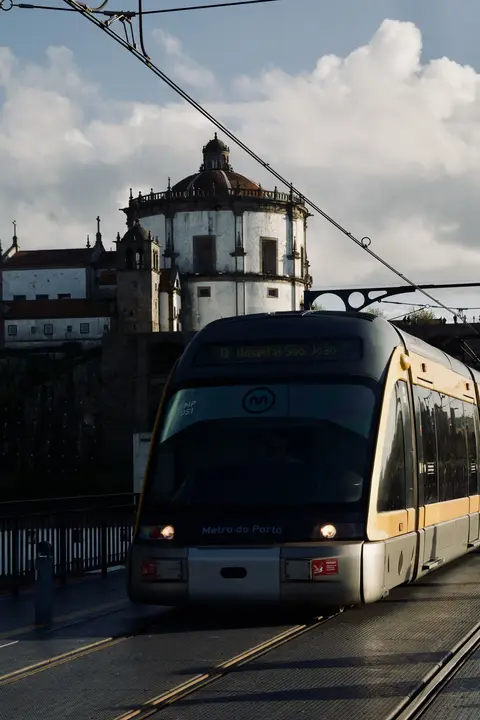 Metro train with a domed monastery behind